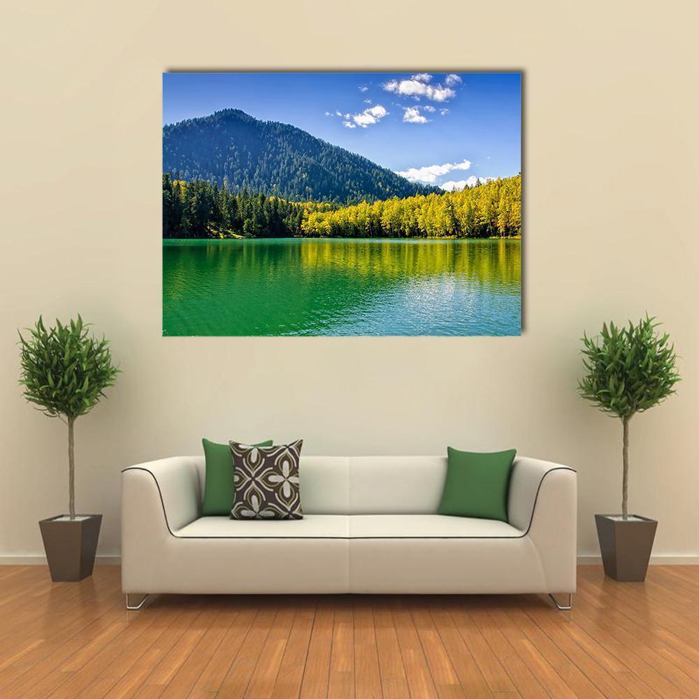 Siberian Lake Reflection Canvas Wall Art in yellow, green and blue, single panel hung on a wall