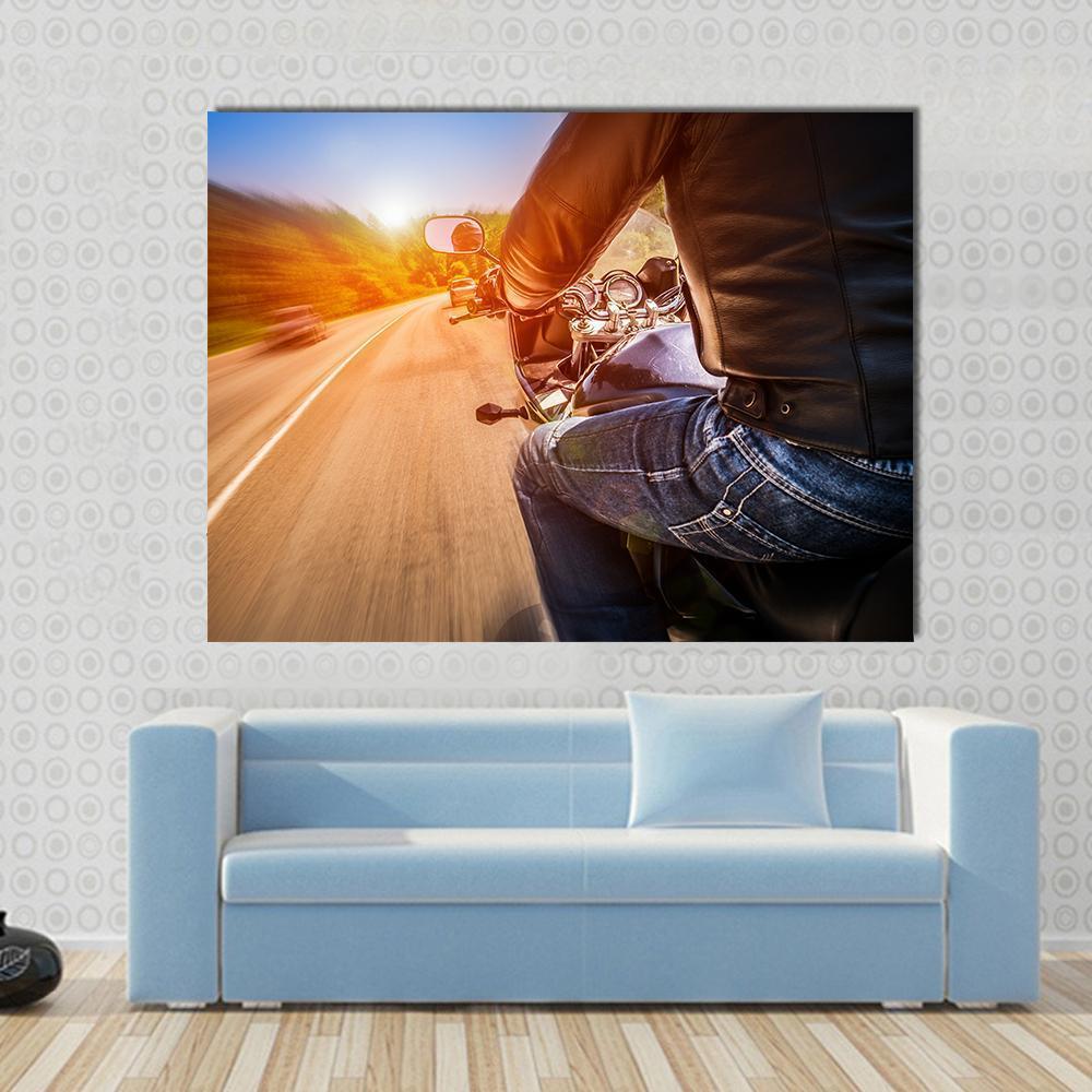 Biker Driving a Motorcycle Canvas Wall Art in black, orange and blue, single panel hung on a wall