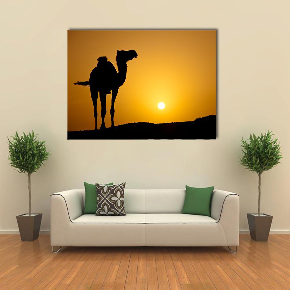 Silhouette of a Wild Camel at Sunset Canvas Wall Art in black, orange and yellow, single panel hung on a wall