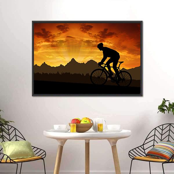 Cyclist Silhouette at Sunset Over Mountains Canvas Wall Art in black, orange and yellow, framed canvas, product view on a white background