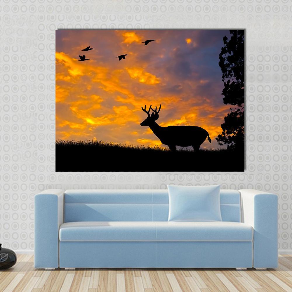 Silhouette of Deer Canvas Wall Art in black, orange and blue, single panel hung on a wall
