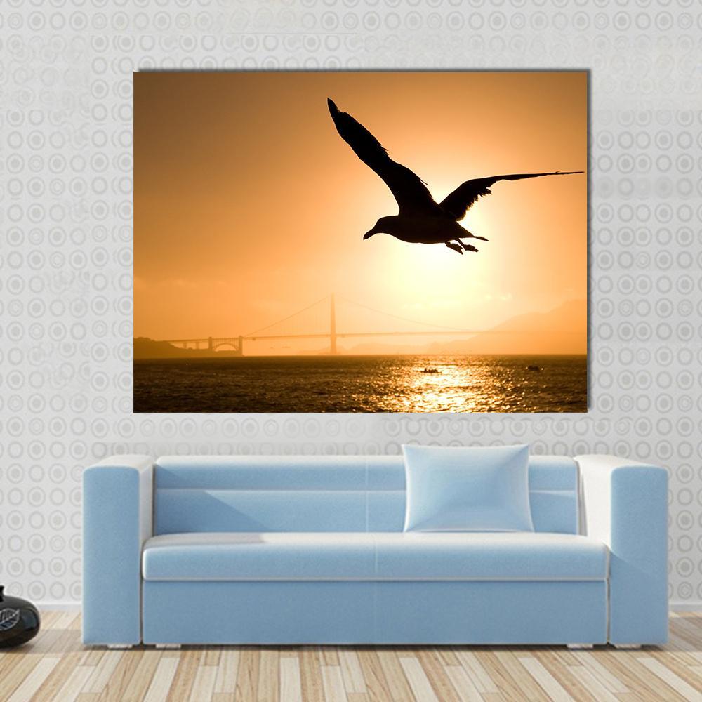 Silhouette of Eagle Canvas Wall Art in black, orange and yellow, single panel hung on a wall