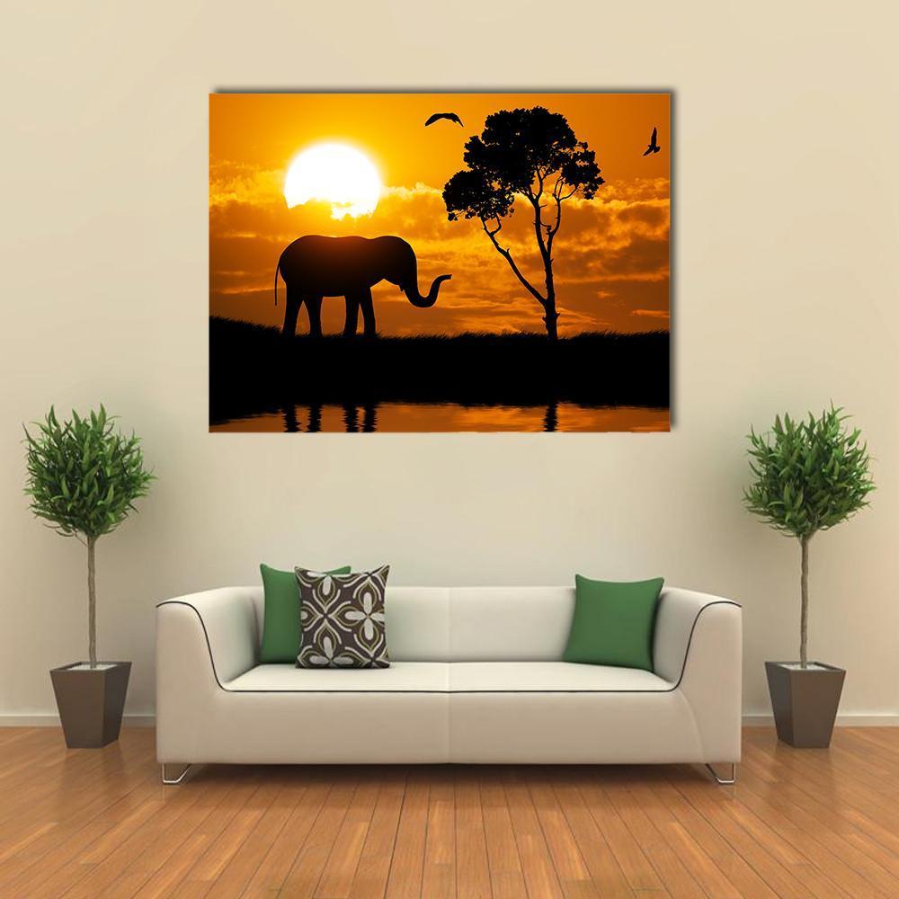 Silhouette of Elephant Canvas Wall Art in black, orange and yellow, single panel hung on a wall