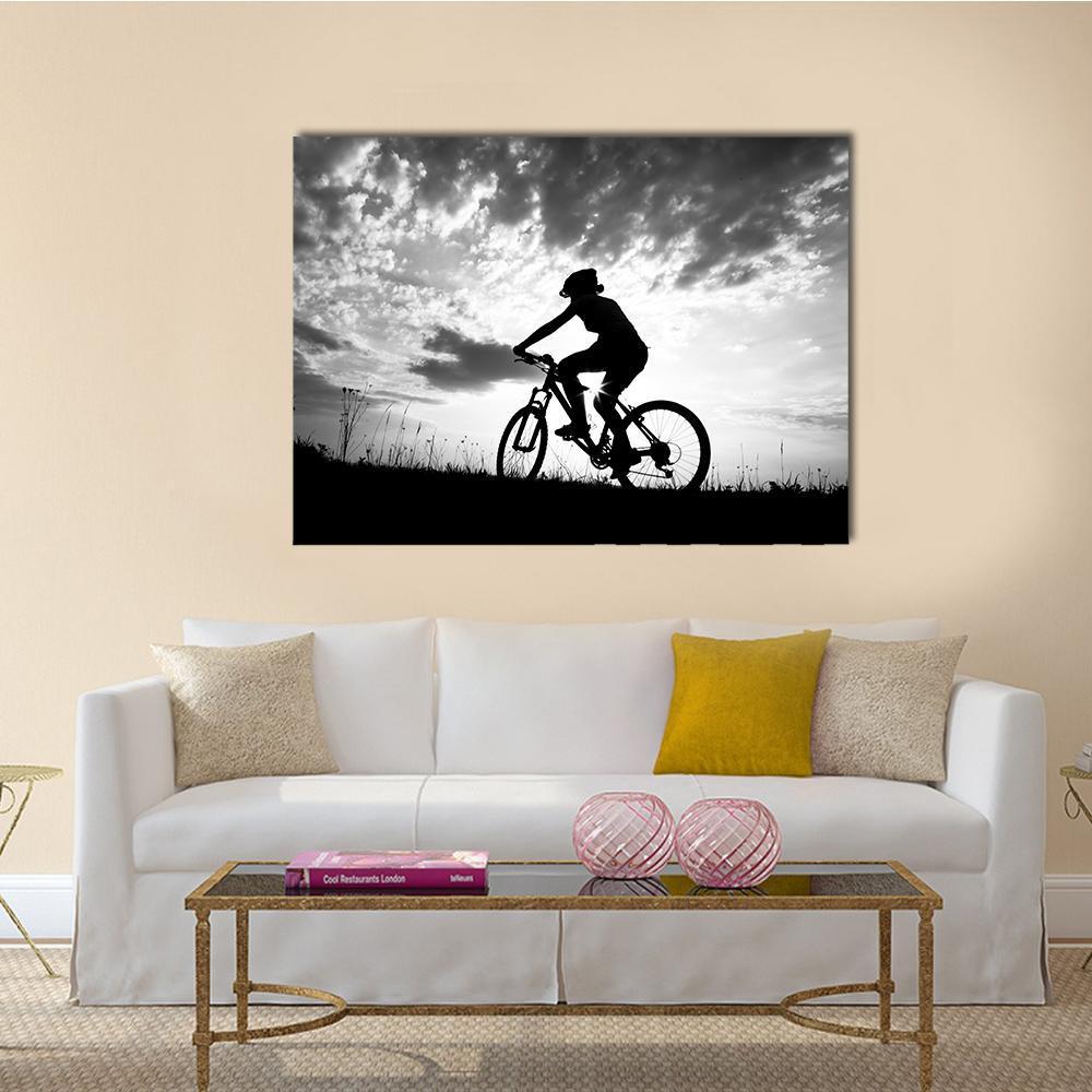 Girl Biker Silhouette at Dusk Canvas Wall Art in black, white and gray, single panel hung on a wall