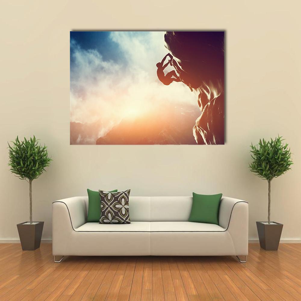 Climber Silhouette at Sunset Canvas Wall Art in black, orange and blue, single panel hung on a wall