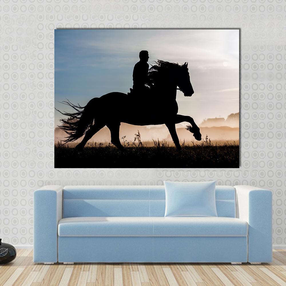 Silhouette of Horse and Rider in Sunset Canvas Wall Art in black, orange and blue, single panel hung on a wall