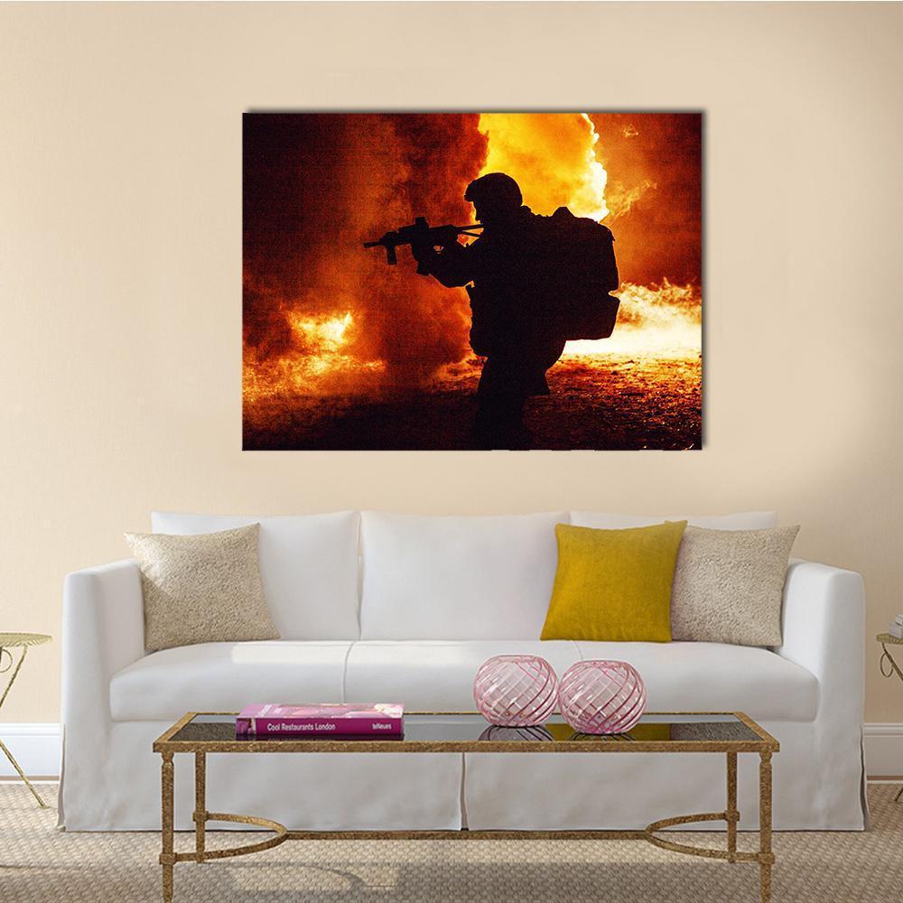 Soldier Silhouette with Fiery Background Canvas Wall Art in black, orange and yellow, single panel hung on a wall