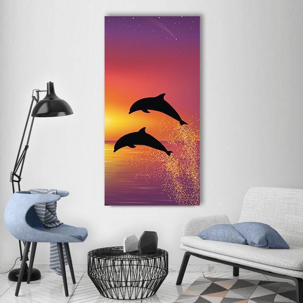 Two Leaping Dolphins at Sunset Vertical Canvas Wall Art in orange, yellow and purple, single vertical panel hung on a wall