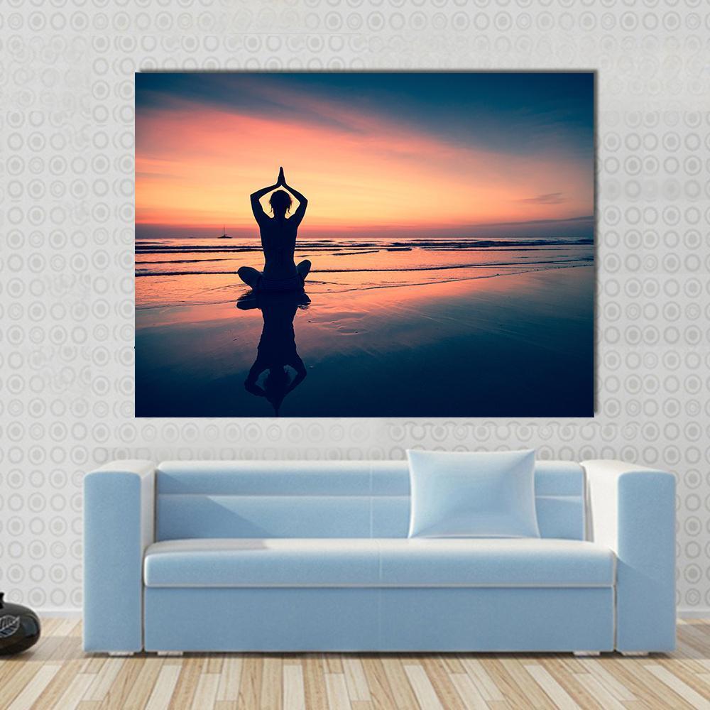 Silhouette of Woman Practicing Yoga at the Seaside Canvas Wall Art in orange, blue and pink, single panel hung on a wall