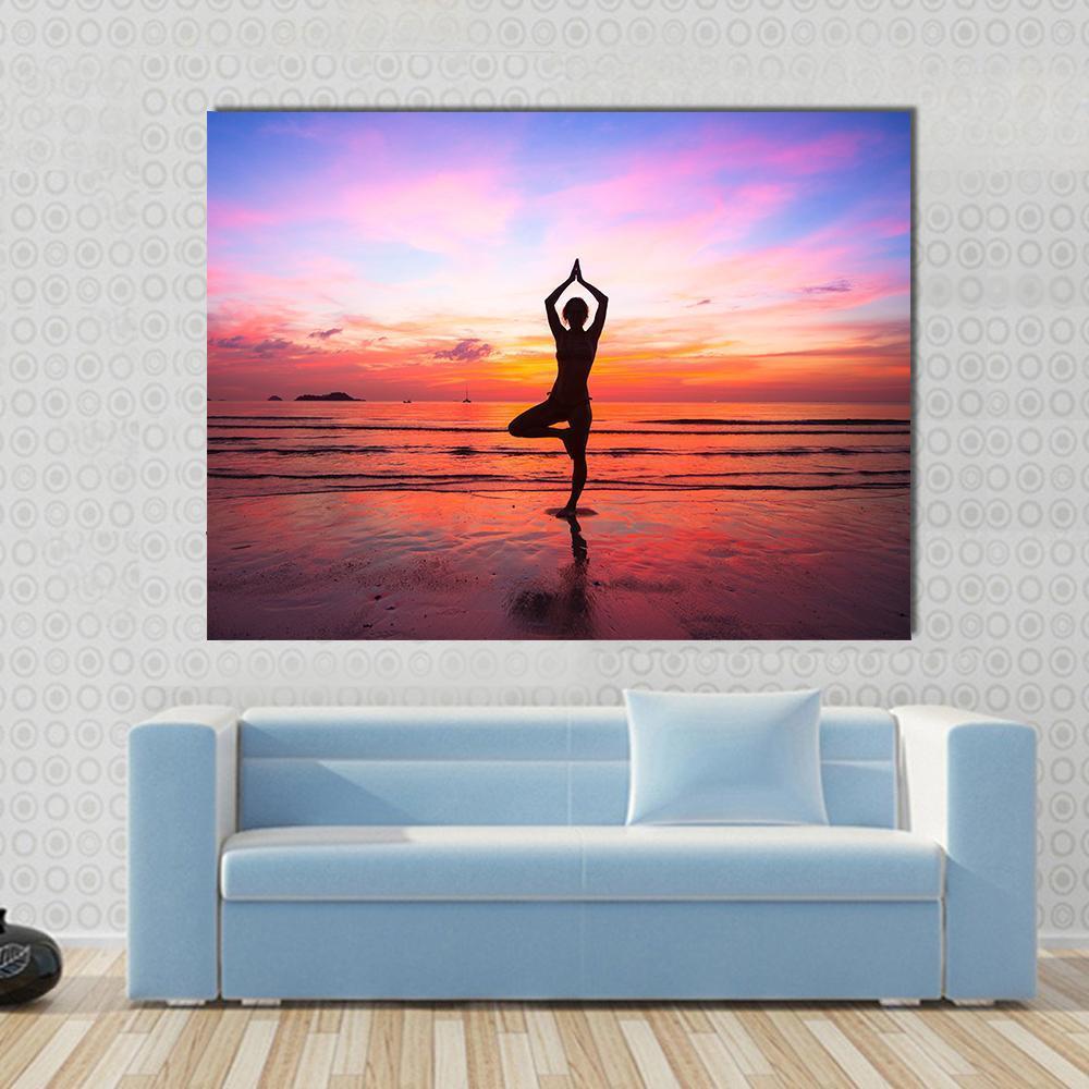 Silhouette Woman Yoga at the Seaside Sunset Canvas Wall Art in orange, purple and pink, single panel hung on a wall