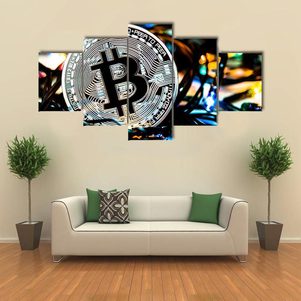 Silver Bitcoin Coin Close-up Canvas Wall Art in black, silver and blue, 4 panel Pop layout hung on a wall