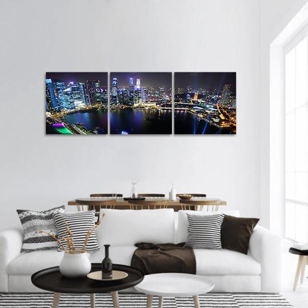 Singapore Night Skyline Panoramic Canvas Wall Art in black and blue, hung on a wall