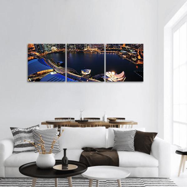 Singapore Cityscape at Night Panoramic Canvas Wall Art in black, orange and blue, hung on a wall