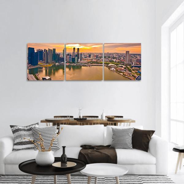 Marina Bay Singapore Skyline at Sunset Panoramic Canvas Wall Art in orange, yellow and blue, hung on a wall