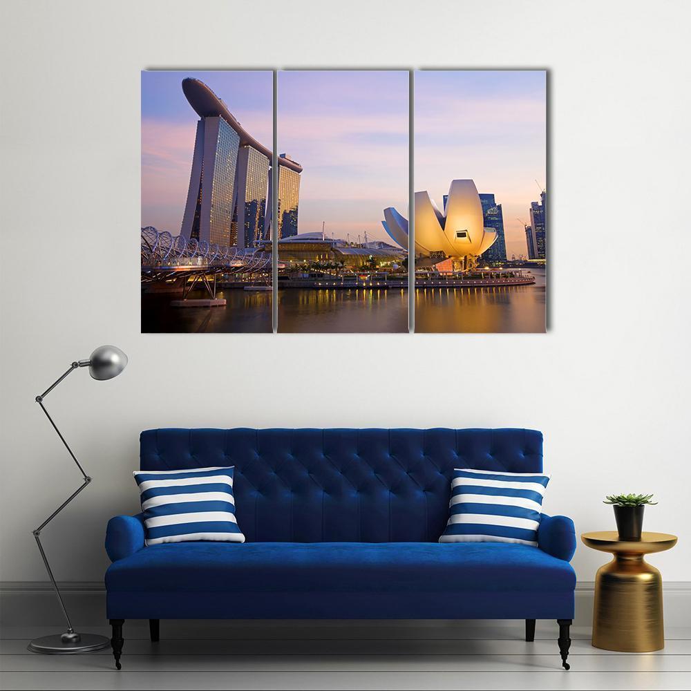 Singapore Skyline at Twilight Canvas Wall Art in gold, blue and purple, 3 panel horizontal set hung on a wall