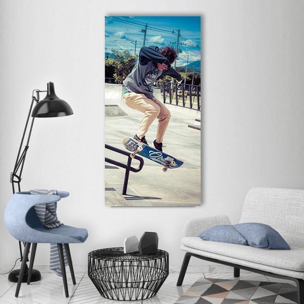 Skateboarder Mid-air at Skatepark Vertical Canvas Wall Art in gray, beige and blue, single vertical panel hung on a wall