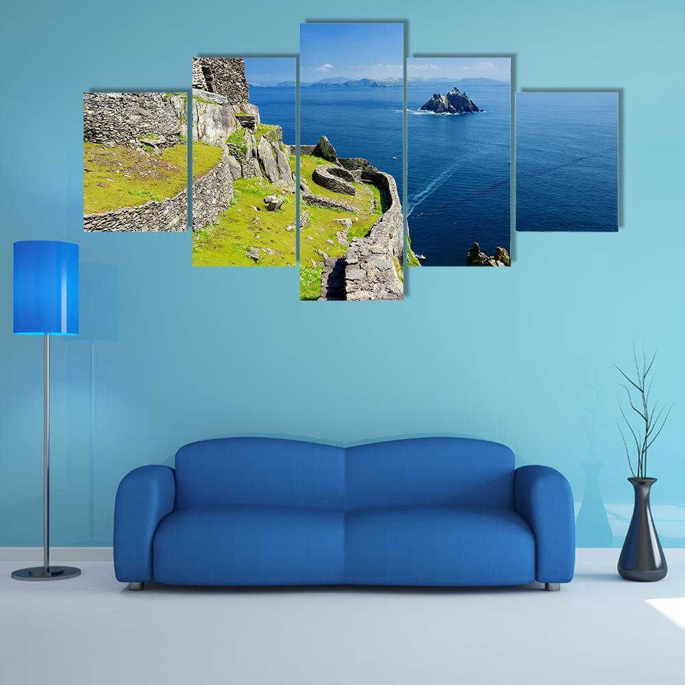 Skellig Michael Monastery Ruins Canvas Wall Art in gray, green and blue, 5 panel Star layout hung on a wall