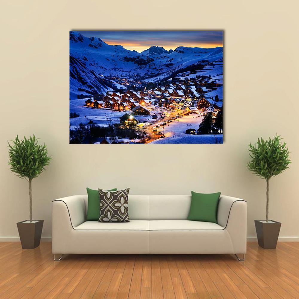 Winter Ski Village at Twilight Canvas Wall Art in white, orange and blue, single panel hung on a wall