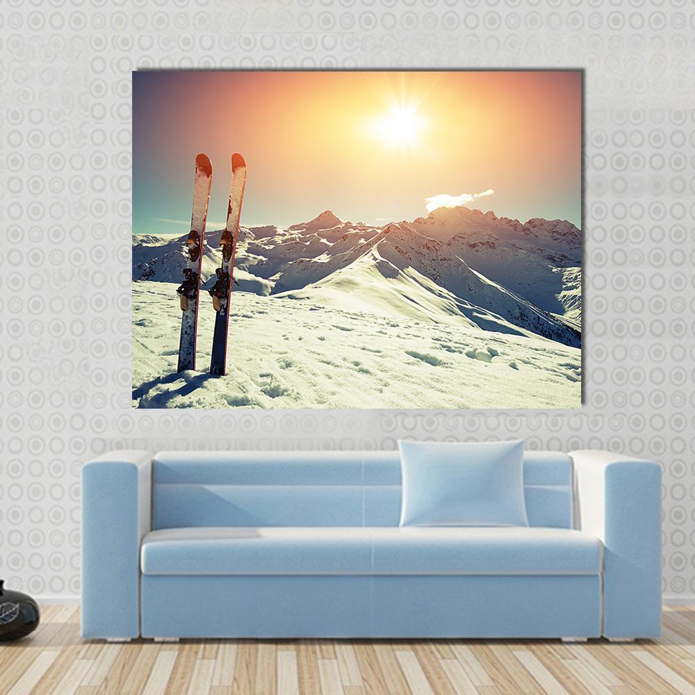 Skis in Snow at Mountains Canvas Wall Art in white, orange and blue, 4 panel Pop layout hung on a wall