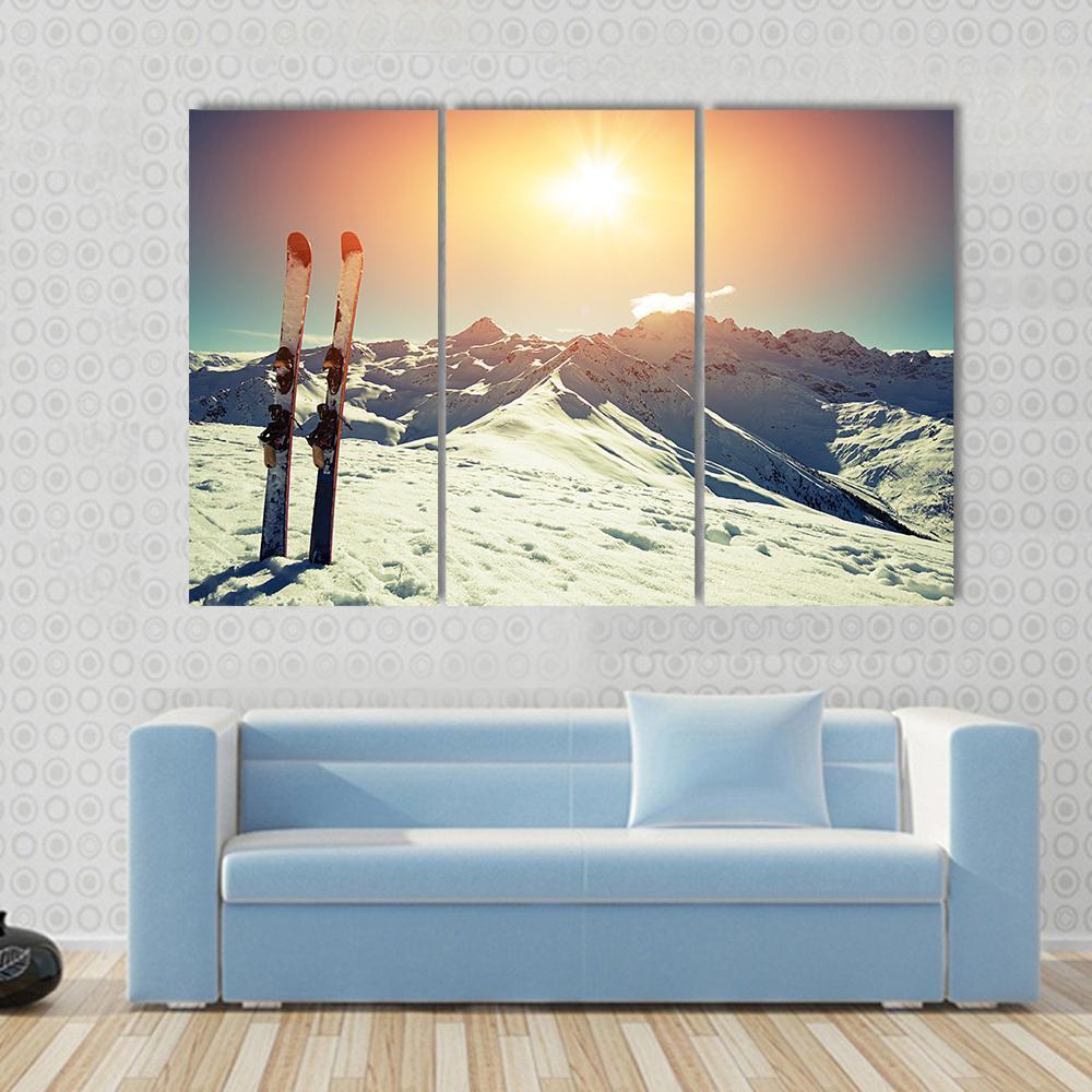 Skis in Snow at Mountains Canvas Wall Art in white, orange and blue, 4 panel Pop layout hung on a wall