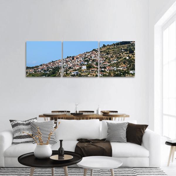 Skopelos Glossa Hillside Village Panoramic Canvas Wall Art in white, green and blue, hung on a wall
