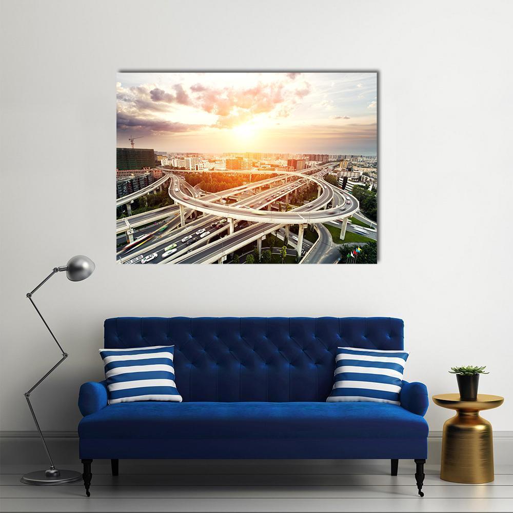 Urban Sunset Over Highway Interchange Canvas Wall Art in white, gray and orange, single panel hung on a wall