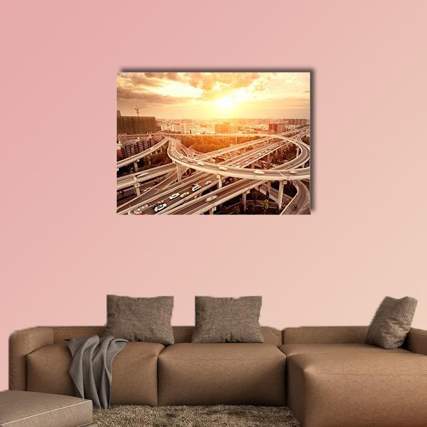 Highway Interchange with City Skyline at Sunset Canvas Wall Art in gray, orange and yellow, single panel hung on a wall