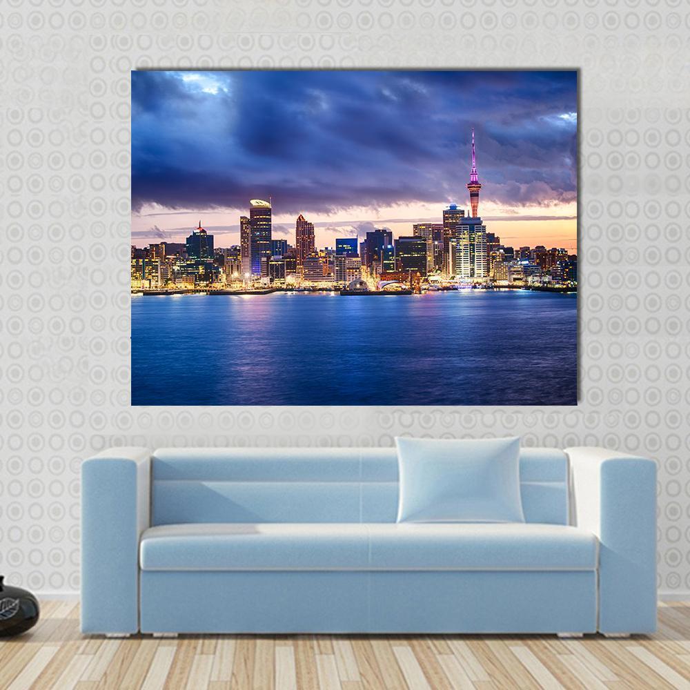 Skyline of Auckland New Zealand Canvas Wall Art in yellow, blue and purple, single panel hung on a wall