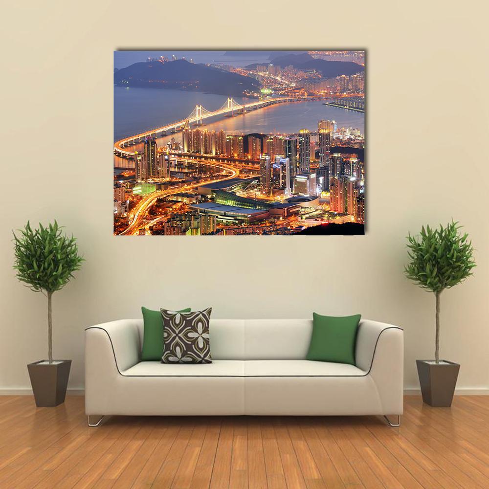 Busan Skyline at Night Canvas Wall Art in orange, yellow and blue, single panel hung on a wall