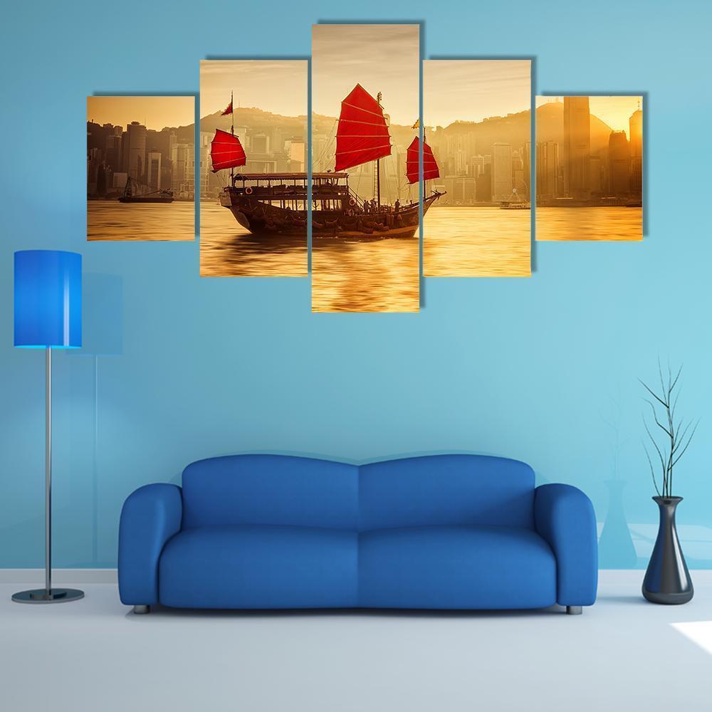 Sunset Skyline with Red-sailed Junk Boat Canvas Wall Art in red, orange and yellow, 5 panel Star layout hung on a wall