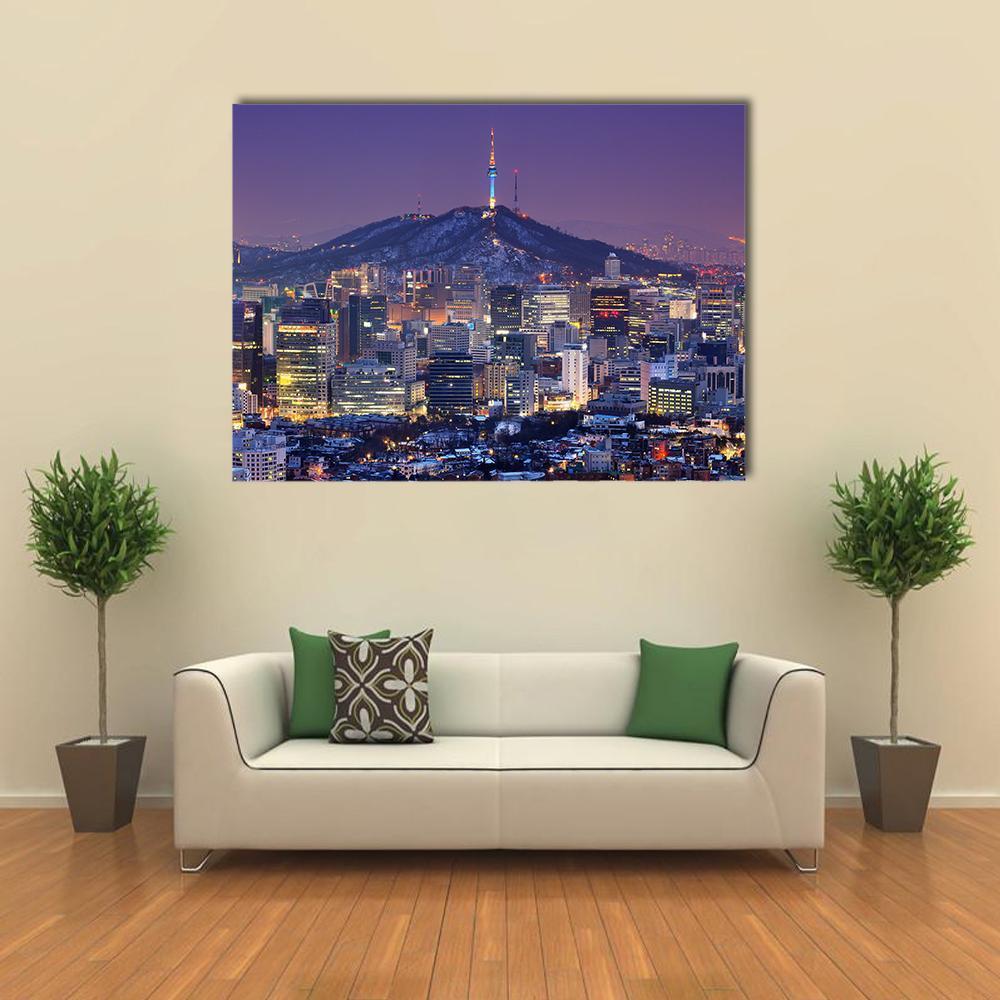 Illuminated Seoul Skyline at Night Canvas Wall Art in yellow, blue and purple, single panel hung on a wall