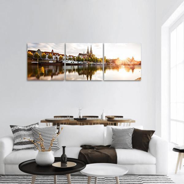 European City Waterfront at Sunset Panoramic Canvas Wall Art in white, brown and orange, hung on a wall