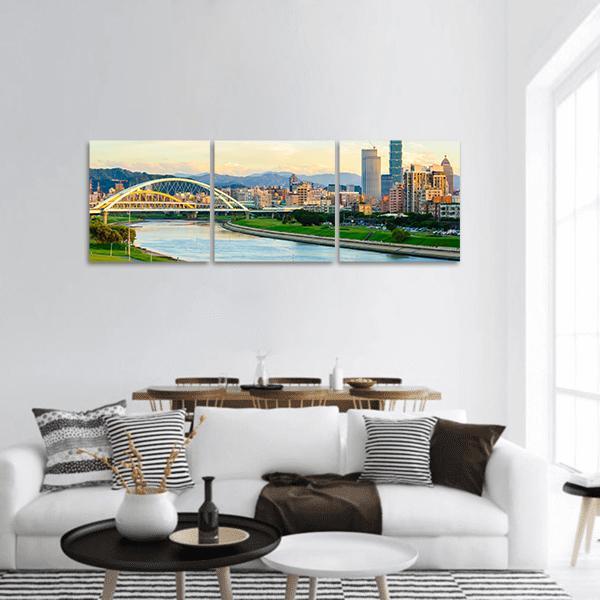 Taipei City Skyline by the River Panoramic Canvas Wall Art in yellow, green and blue, hung on a wall