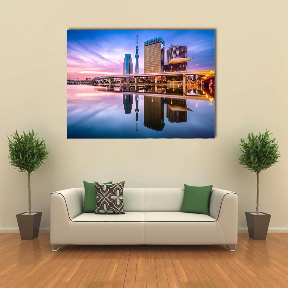 Skyline Reflection on the Sumida River at Dawn Canvas Wall Art in blue, purple and pink, single panel hung on a wall