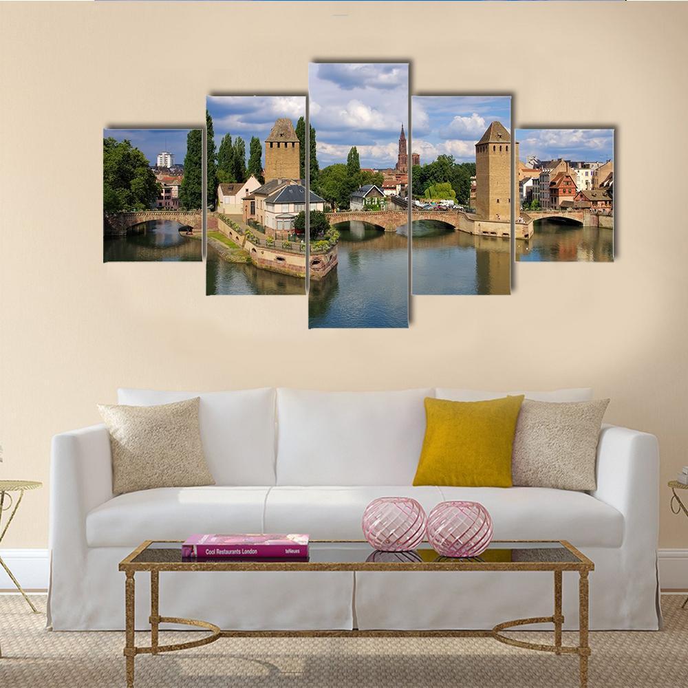 Strasbourg Skyline in Alsace Canvas Wall Art in beige, green and blue, 5 panel Star layout hung on a wall