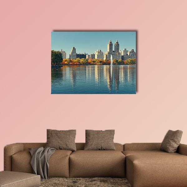 Manhattan Skyline Over Lake with Fountain Canvas Wall Art in gray and blue, single panel hung on a wall