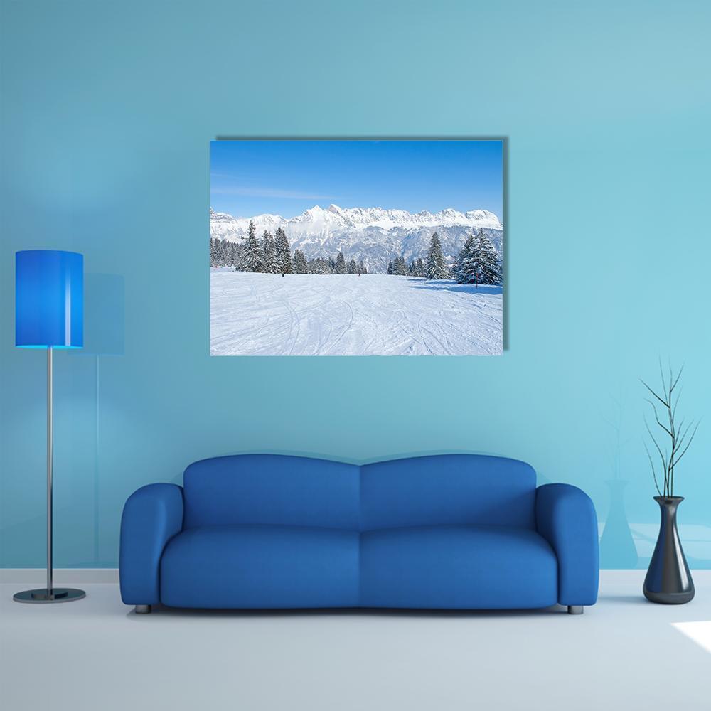 Snowy Ski Slope Landscape Canvas Wall Art in white and blue, single panel hung on a wall