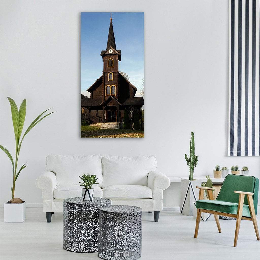 Slovakia Wooden Church with Steeple Vertical Canvas Wall Art in black, brown and blue, single vertical panel hung on a wall
