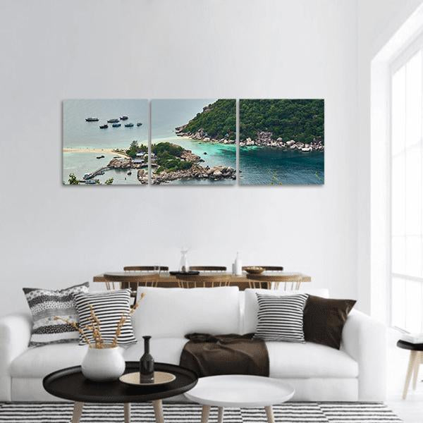 Tropical Island with Sandbar and Anchored Boats Panoramic Canvas Wall Art in beige, green and blue, hung on a wall