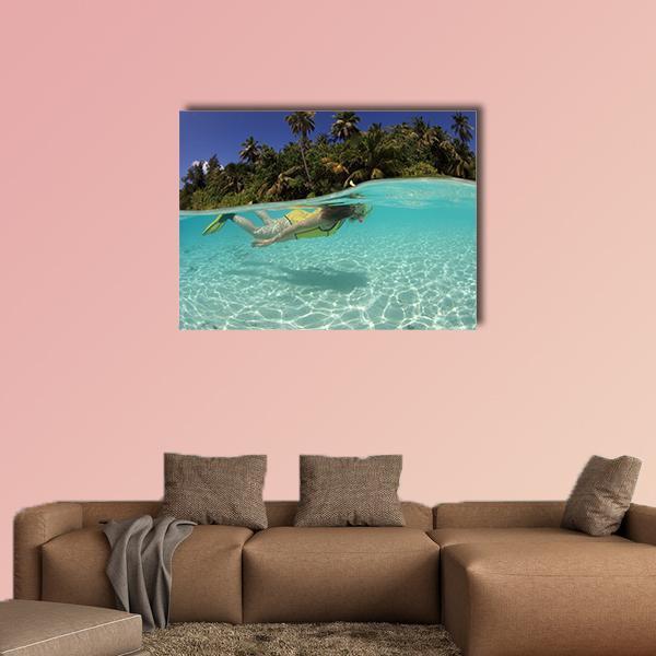 Snorkeler in Blue Lagoon Canvas Wall Art in white, green and blue, single panel hung on a wall