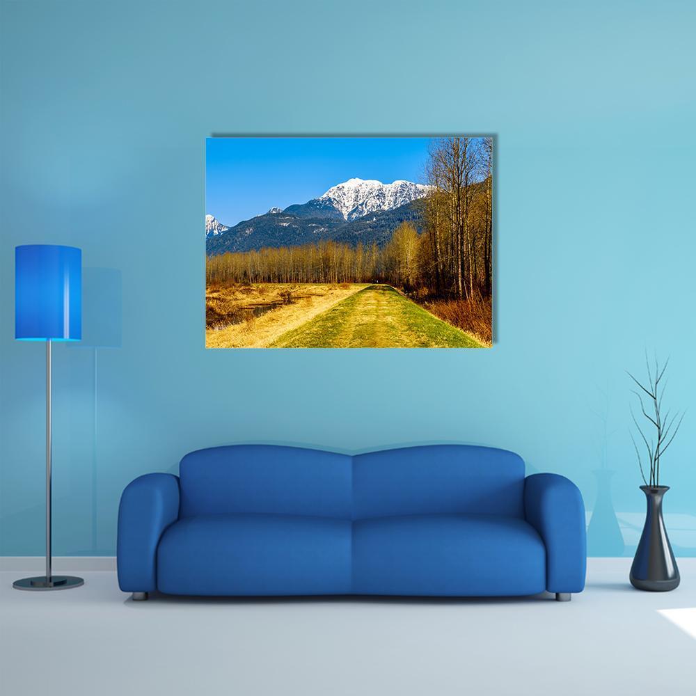 Snow Covered Golden Ears Mountain Canvas Wall Art in white, yellow and blue, single panel hung on a wall