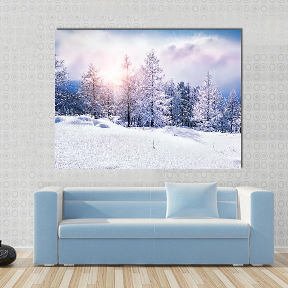 Snow Covered Trees at Sunset Canvas Wall Art in white, blue and pink, single panel hung on a wall