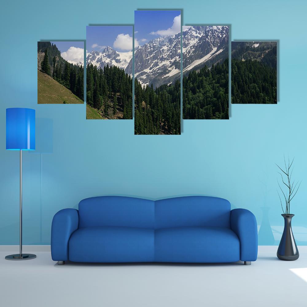 Snow-capped Mountain and Pine Forest Canvas Wall Art in white, green and blue, 5 panel Star layout hung on a wall