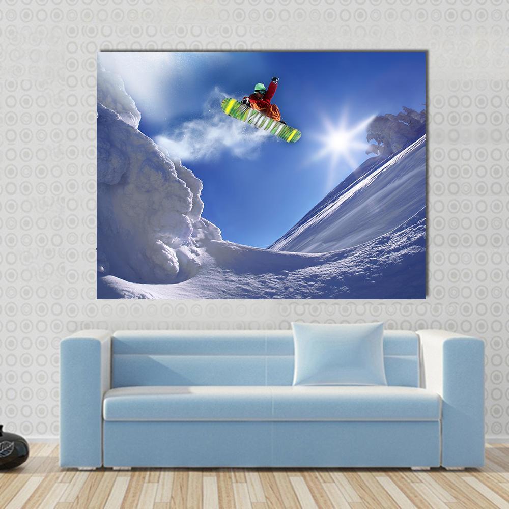 Snowboarder Jumping Against Blue Sky Canvas Wall Art in white and blue, single panel hung on a wall