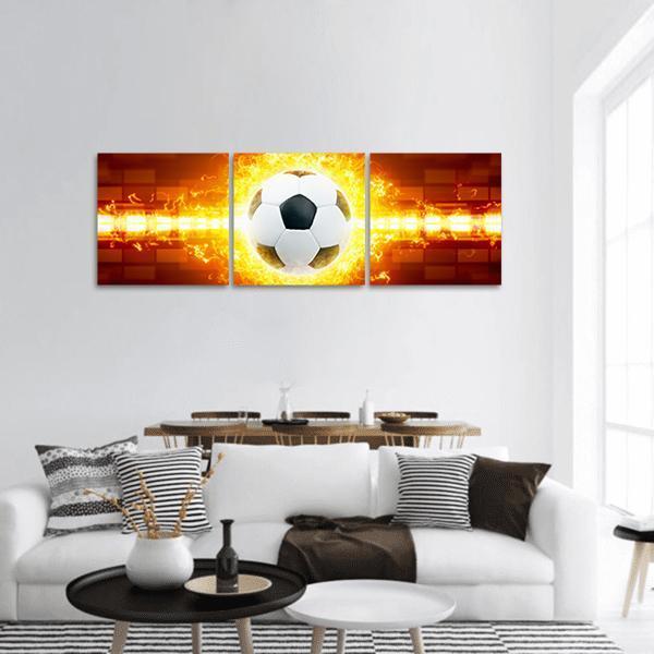 Soccer Ball Surrounded by Flames Panoramic Canvas Wall Art in brown, orange and yellow, hung on a wall