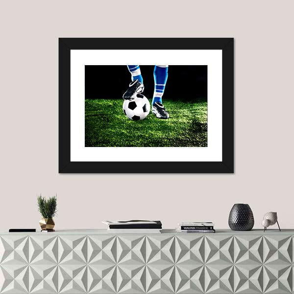 Soccer Ball and Player Canvas Wall Art in black, white and green, hung on a wall