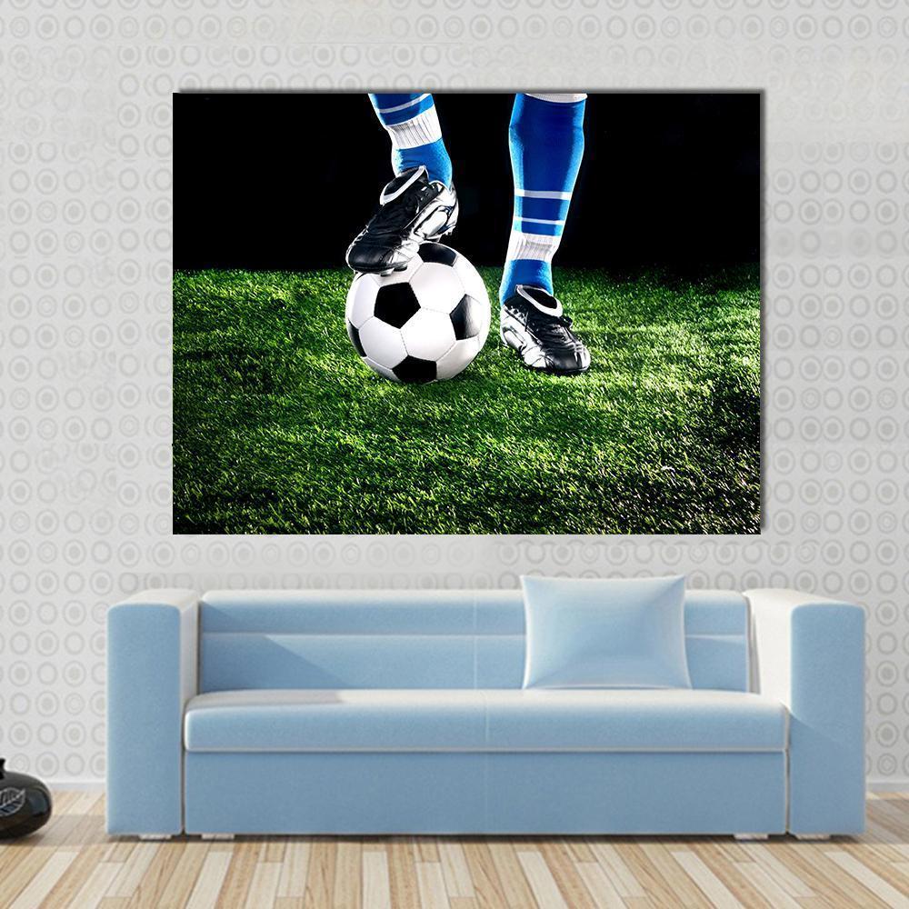 Soccer Ball and Player Canvas Wall Art in black, white and green, hung on a wall