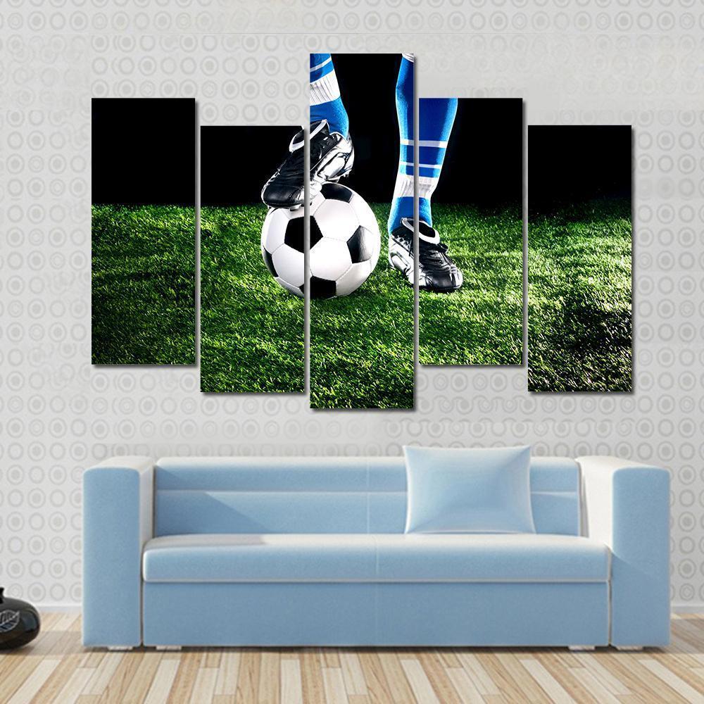 Soccer Ball and Player Canvas Wall Art in black, white and green, hung on a wall