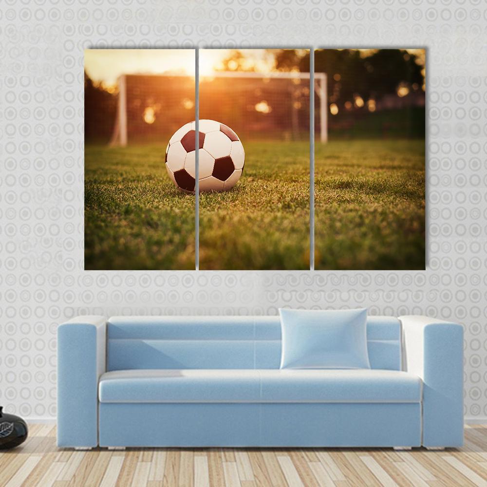 Soccer at Sunset Canvas Wall Art in orange, yellow and green, 5 panel Pop layout hung on a wall