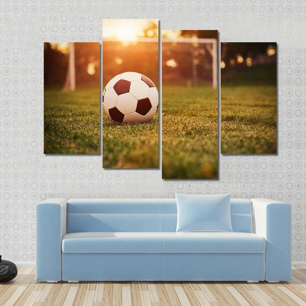 Soccer at Sunset Canvas Wall Art in orange, yellow and green, 5 panel Pop layout hung on a wall